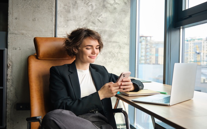 Woman sits in the office with her laptop and works