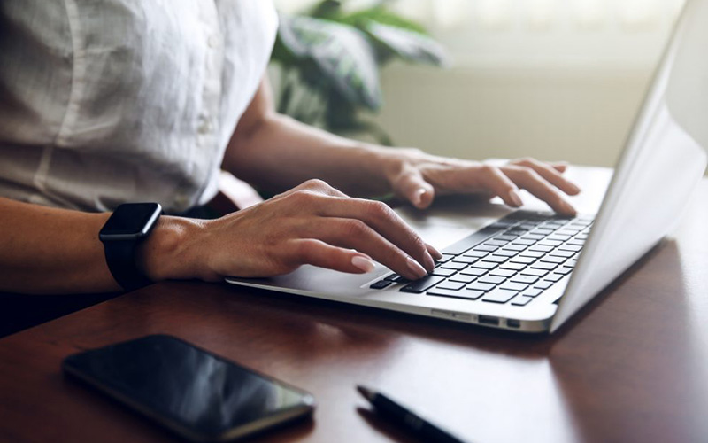 Person typing on a laptop