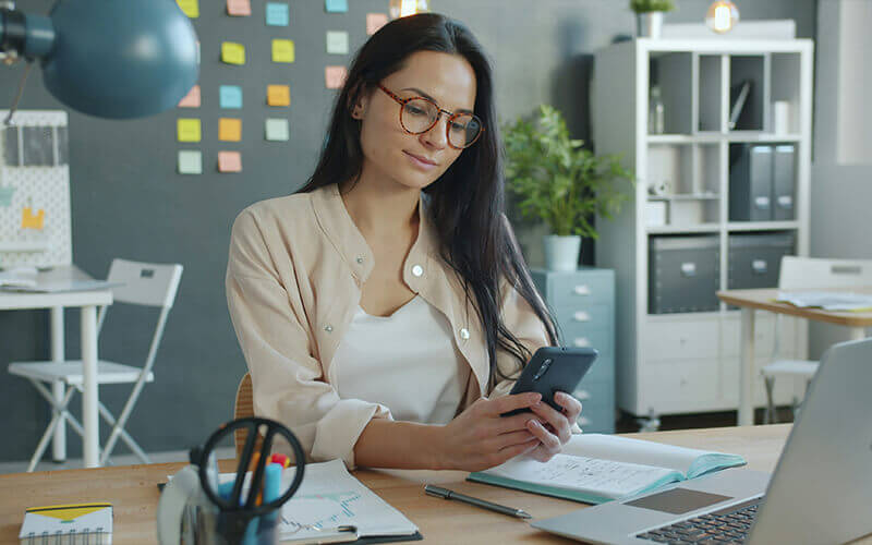 Woman sitting at her desk and working on her laptop